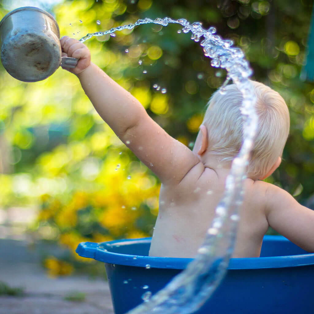 baby in water bucket