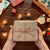 hands holding brown wrapped package with christmas lights in background