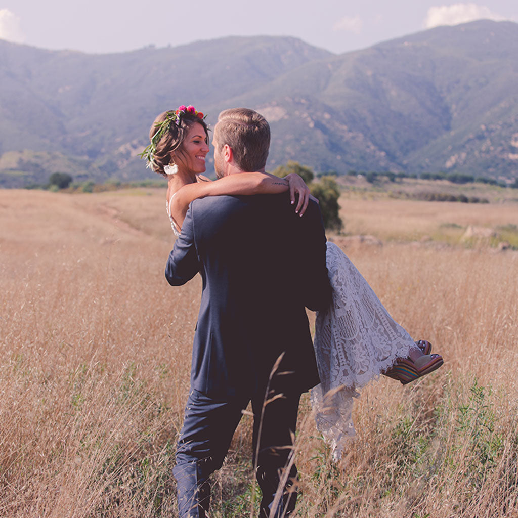 josh holding jj for wedding photo in front of mountains