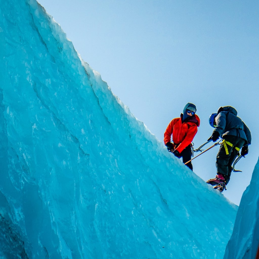 Men glacier ice climbing.