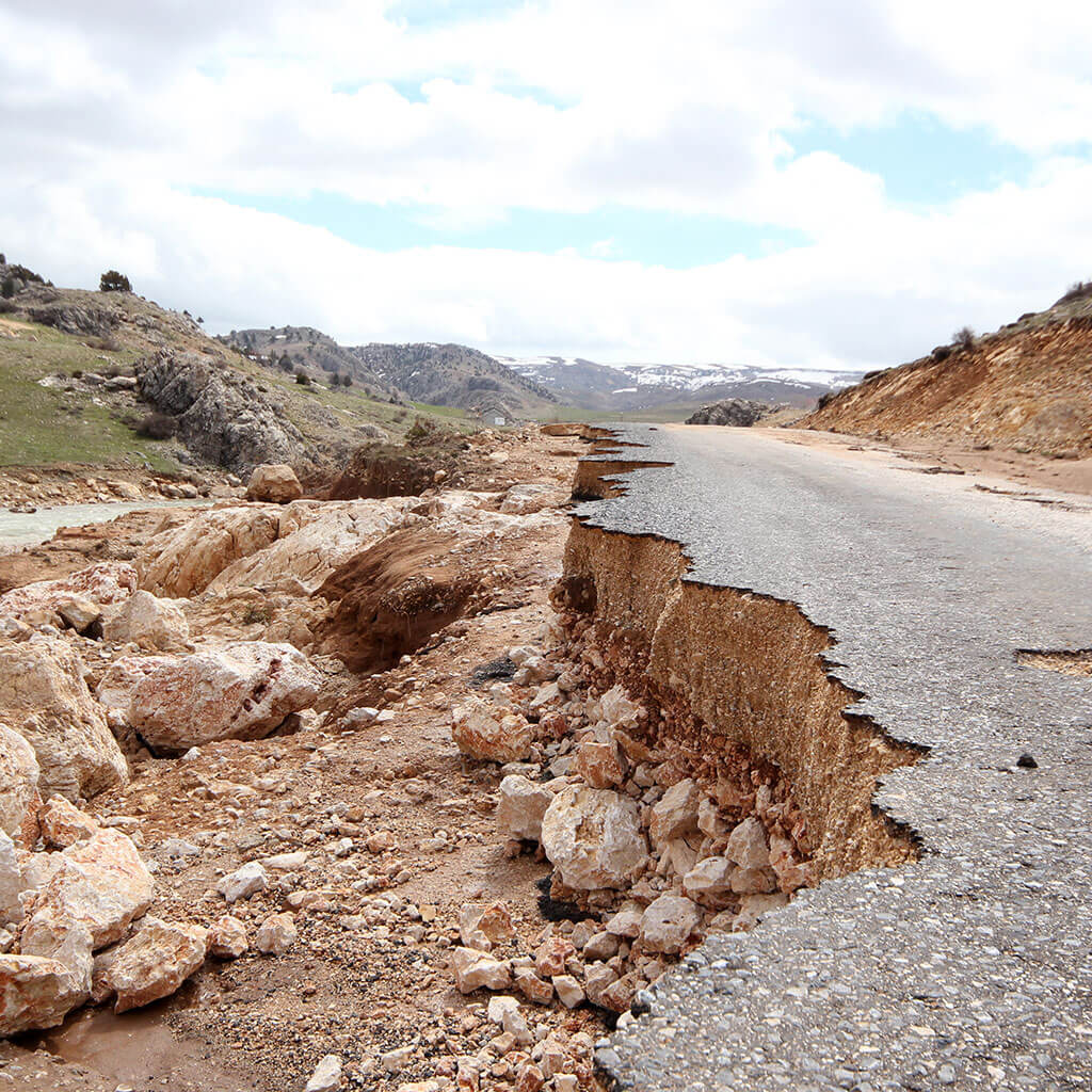 paved road torn apart by earthquake