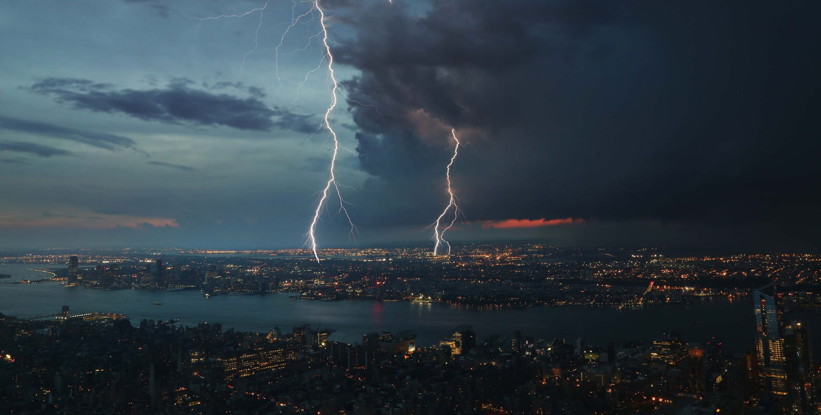 lightning strikes over city at night