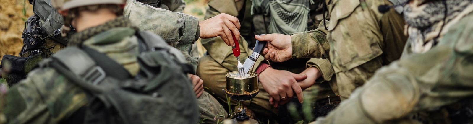 military warfighters eating from campstove