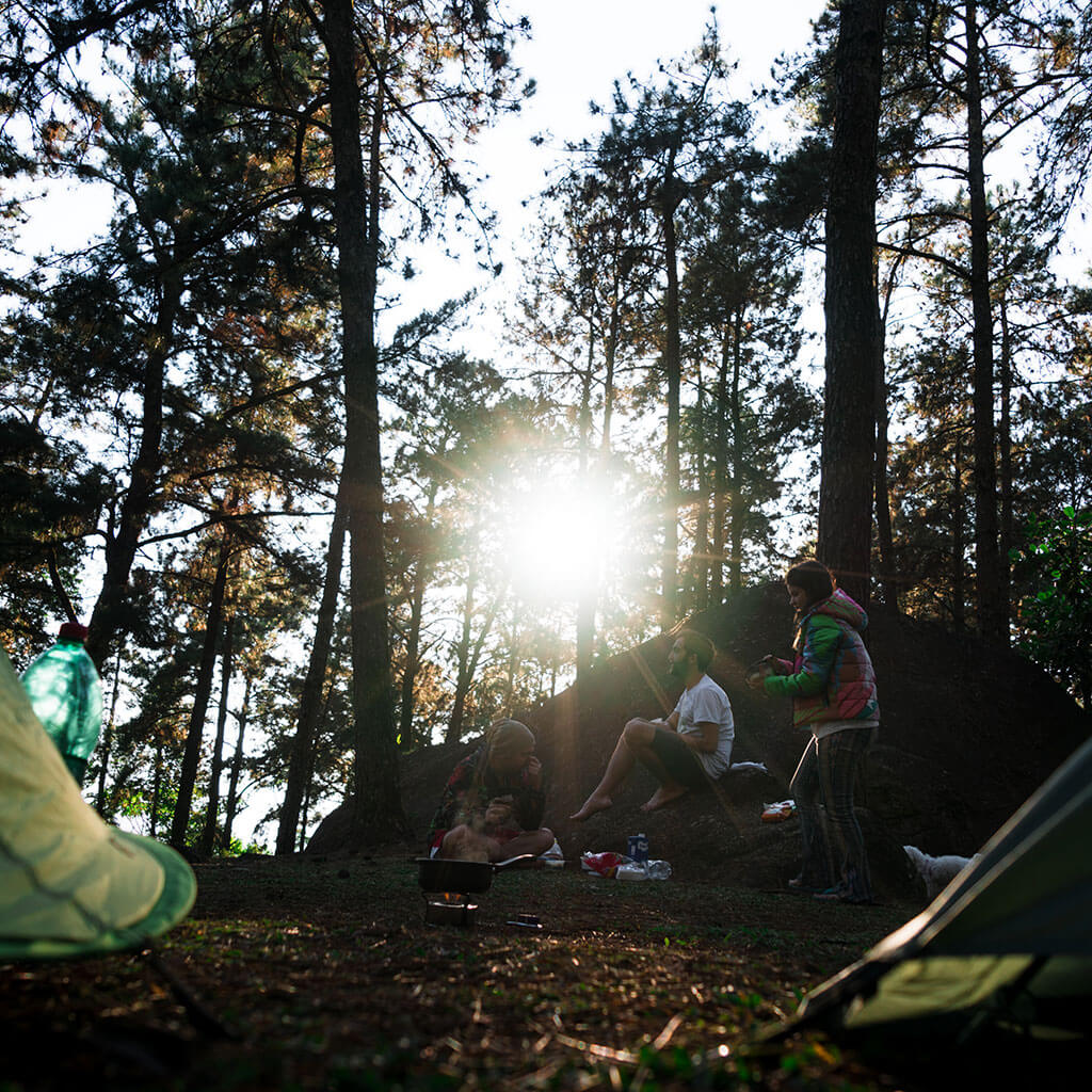 three people eating breakfast at camp