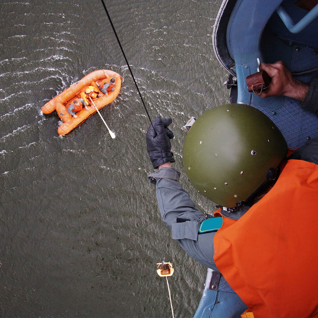 coast guard rescuing survivors from raft