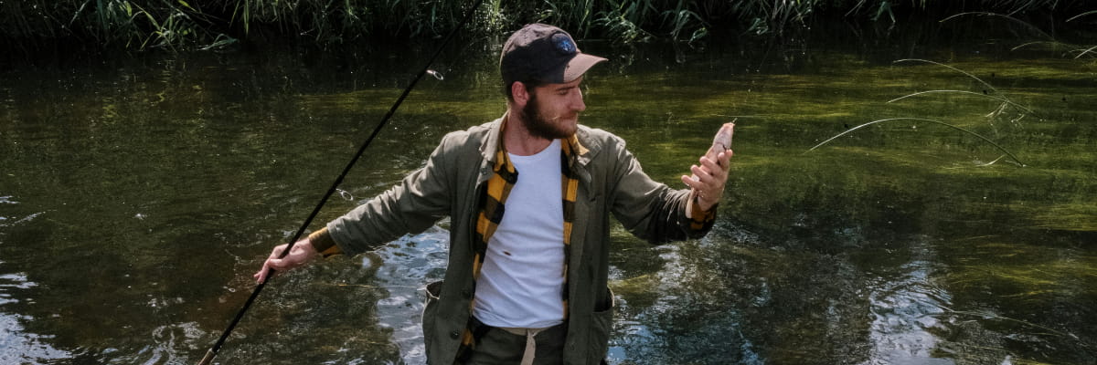 Fisherman holding the bass fish he just caught.