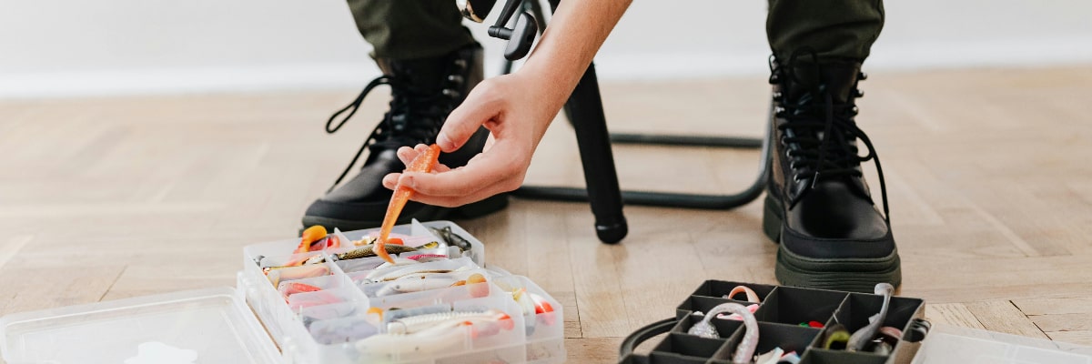 Close-up of a fisherman prepping his tackle box before a fishing trip.