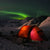 glowing red tent with the aurora in the background