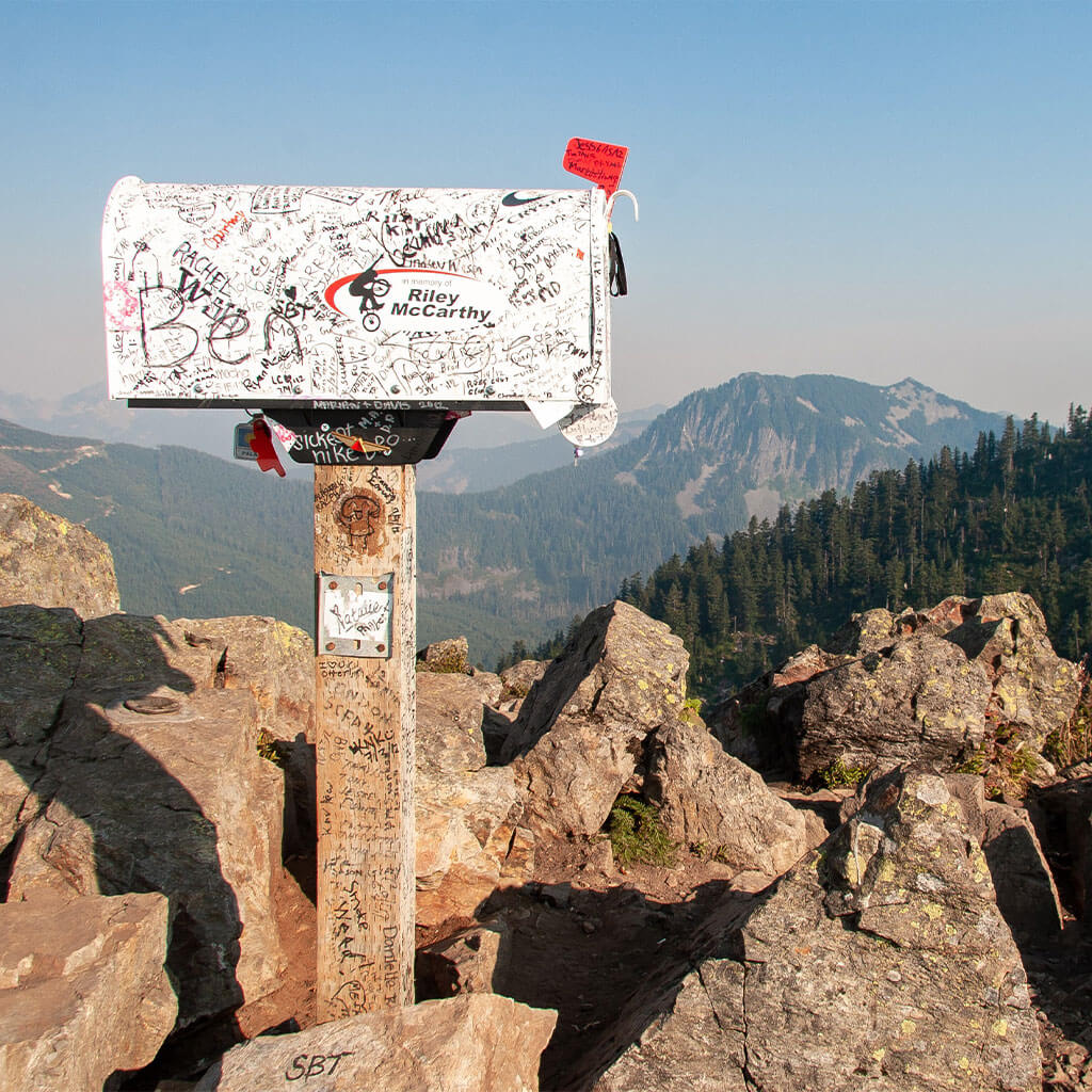 mailbox on top of mountain peak with flag up