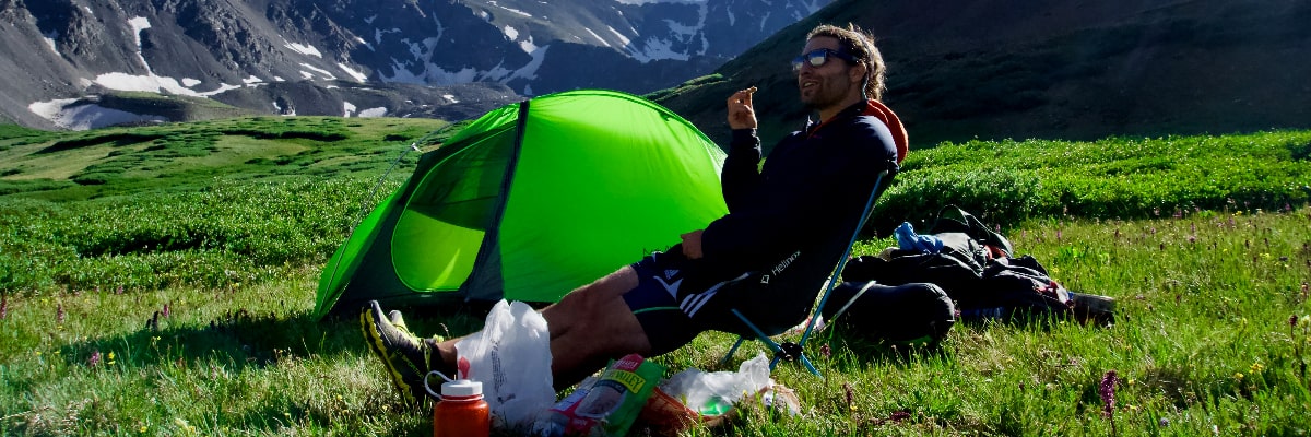 Man eating a delicious no-cook camping meal.