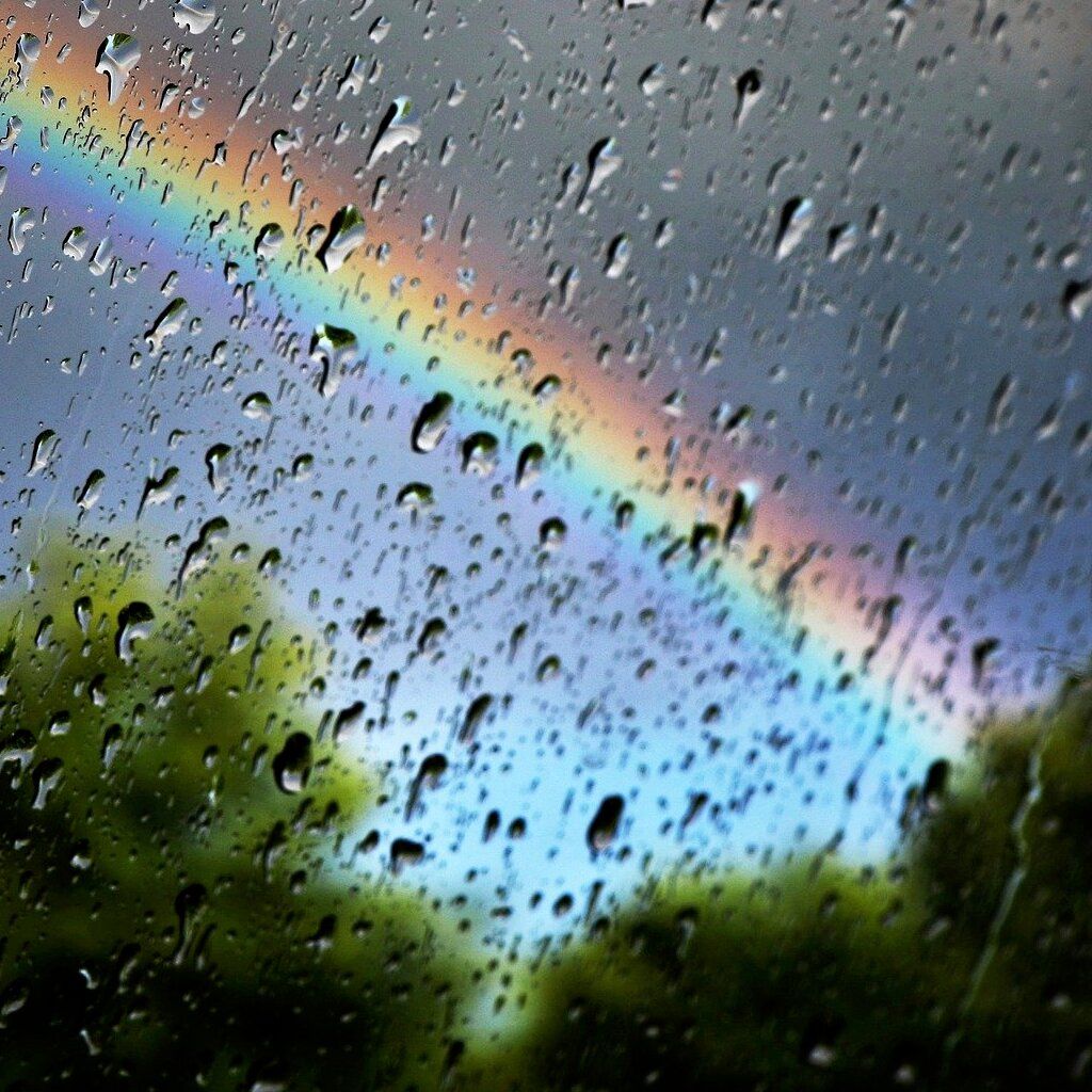 Rainbow from behind wet window.