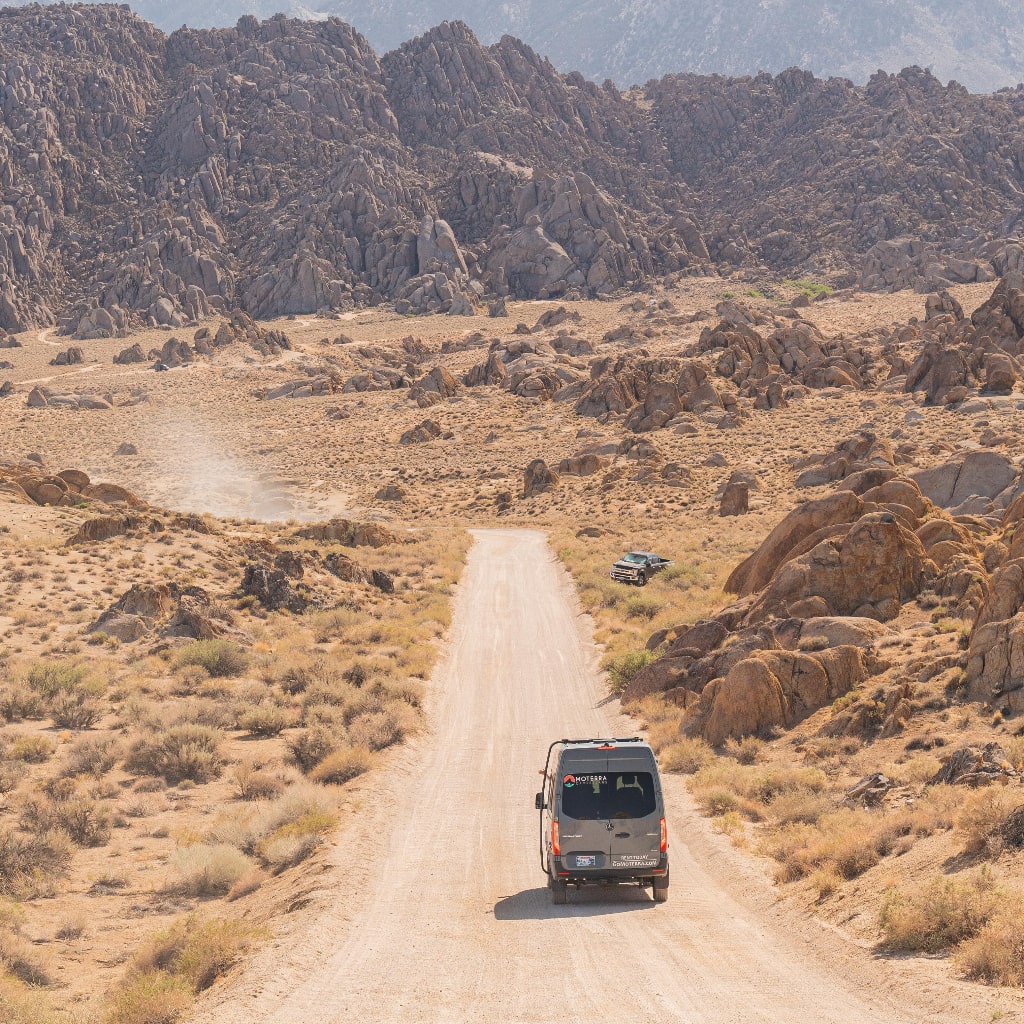 Van driving through the desert.