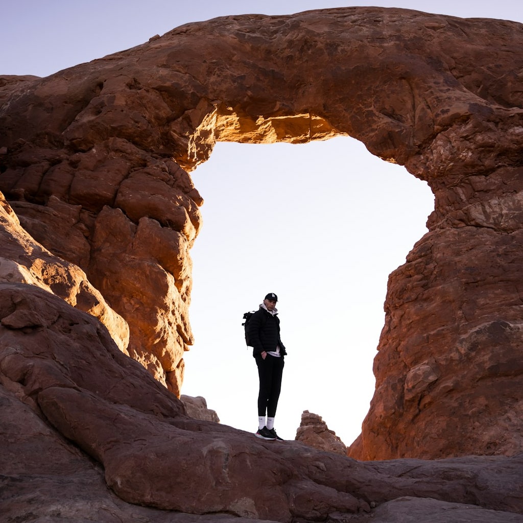 Man hiking in a desert during the winter.