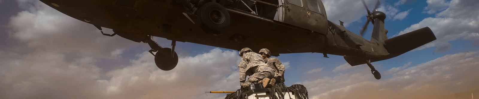 Military helicopter and soldiers with supply drop