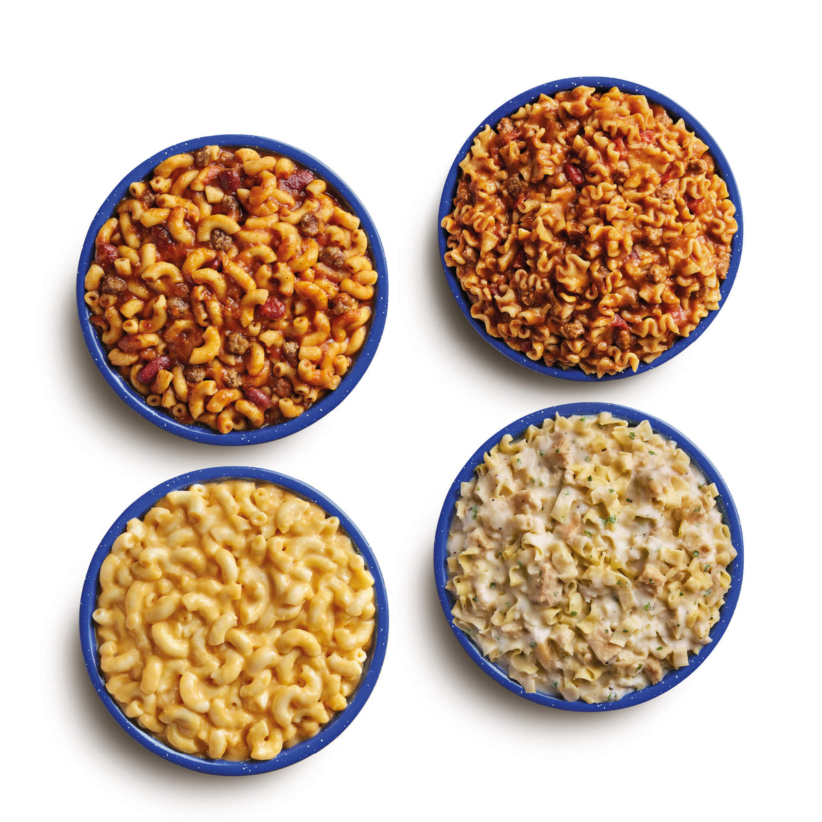 Aerial view of prepared freeze-dried meals in blue camping bowls. Meals shown are Chili Mac, Beef Lasagna, Creamy Mac & Cheese, and Fettuccine Alfredo with Chicken.