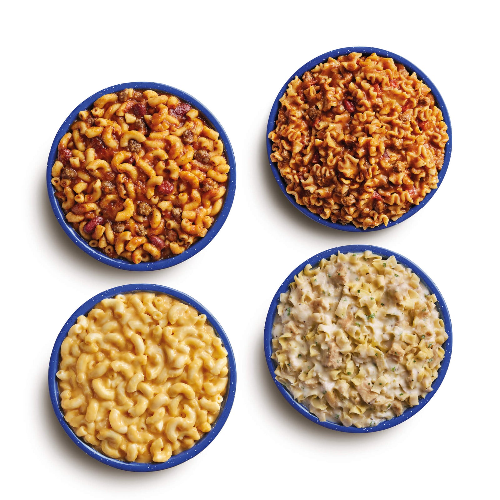 Aerial view of prepared freeze-dried meals in blue camping bowls. Meals shown are Chili Mac, Beef Lasagna, Creamy Mac & Cheese, and Fettuccine Alfredo with Chicken.