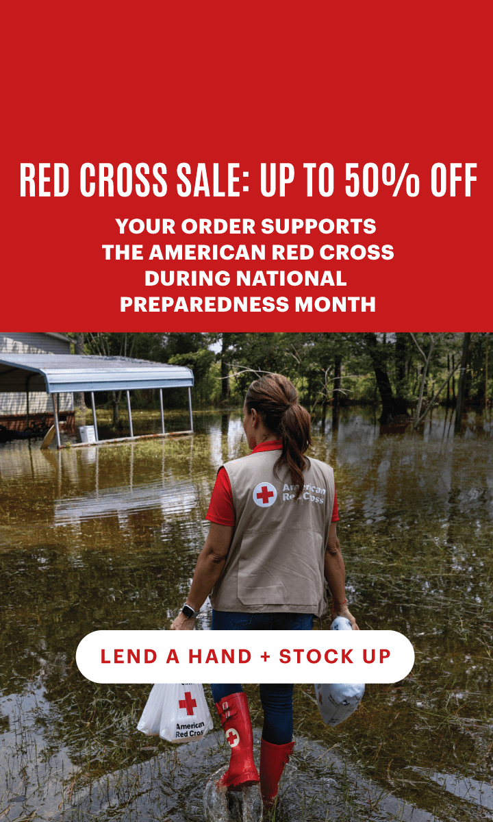 Red Cross volunteer in floodwaters with text that reads, "Red Cross Sale: Up to 50% Off. Your order supports The American Red Cross during National Preparedness Month." White button text reads, "Lend a Hand + Stock Up".