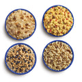 Four blue camping bowls filled with various Mountain House meals in the 14-Day Kit.