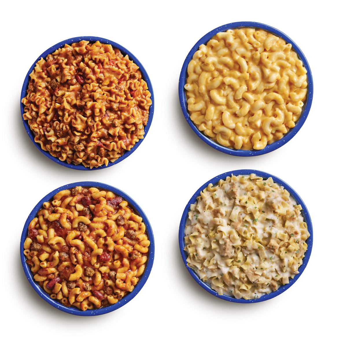 Four blue camping bowls filled with various Mountain House meals in the 14-Day Kit.