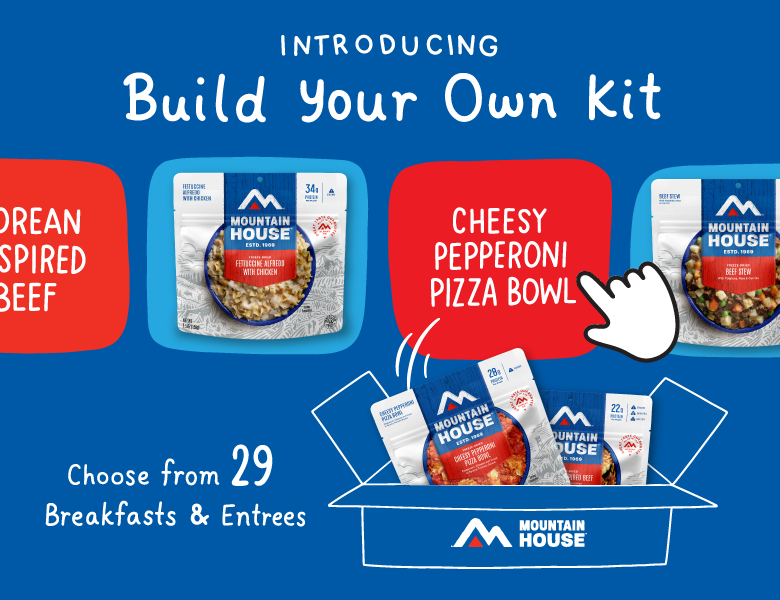 Blue background with Mountain House pouches being put into box. Text reads "Introducing Build Your Own Kit. Choose from 29 Breakfasts & Entrees."