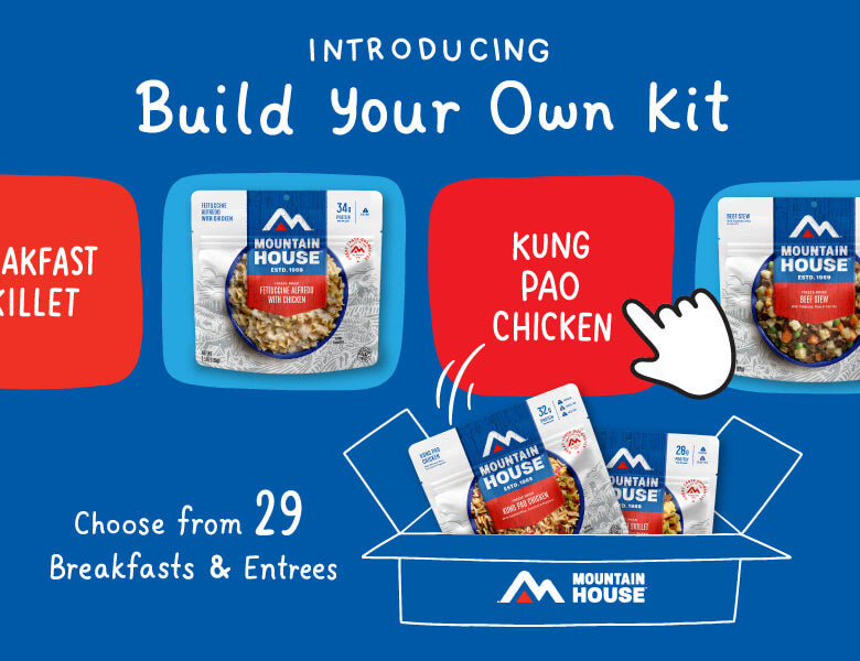 Blue background with Mountain House pouches being put into box. Text reads "Introducing Build Your Own Kit. Choose from 29 Breakfasts & Entrees."