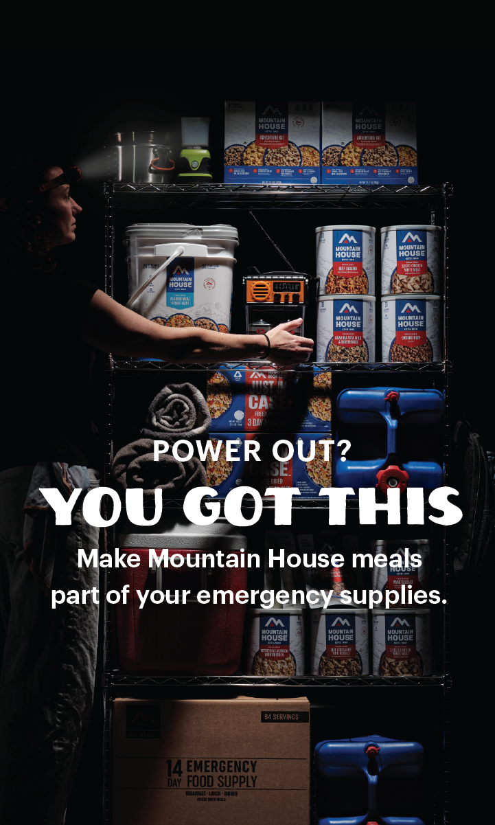 Person reaching for emergency supplies during a power outage. Text reads, "Power Out? You Got This. Make Mountain House meals part of your emergency supplies."