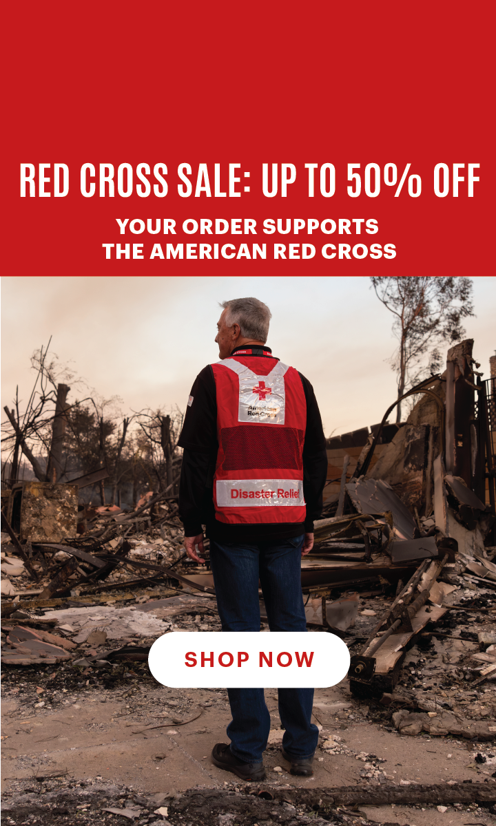 Red Cross disaster relief volunteer looking at damage caused by wildfire. Text reads, "Red Cross Sale: Up to 50% Off. Your order supports the Red Cross". White button text reads, "Shop Now.