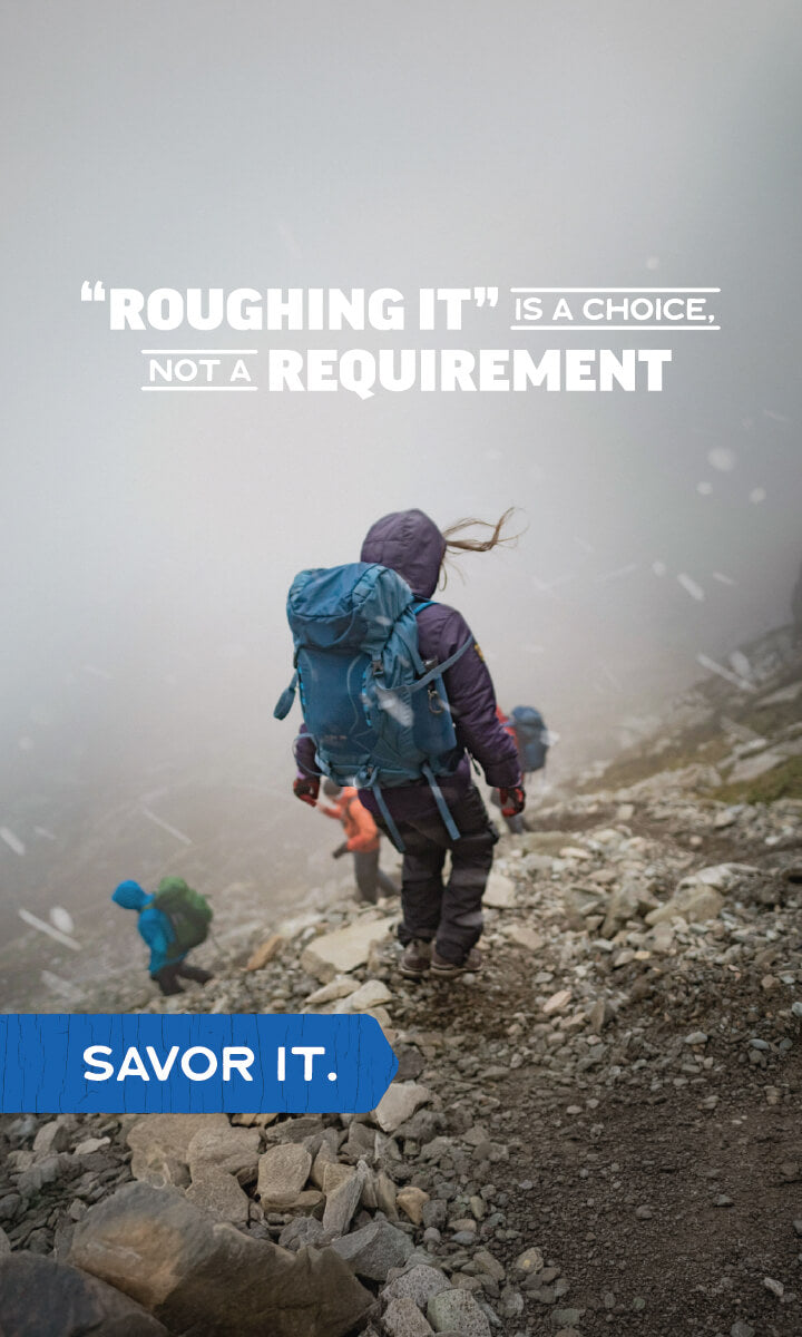 Hikers on a misty mountain trail with text: “Roughing it is a choice, not a requirement—savor it."