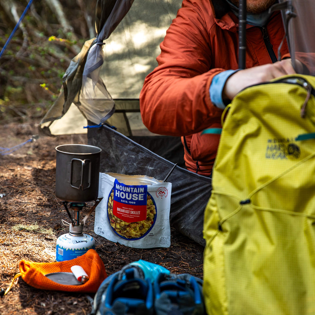 Mountain House Breakfast Skillet pouch and camp stove outside of tent.