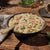 Bowl of chicken and dumplings with vegetables on a wooden table