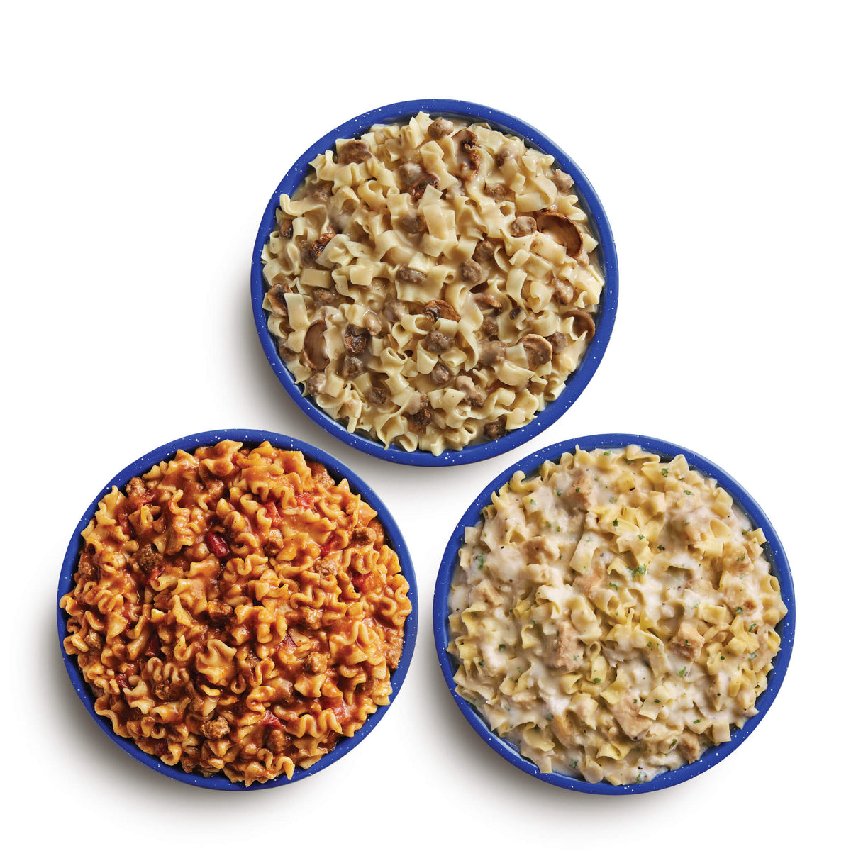 Three blue camping bowls filled with various Mountain House pasta dishes.
