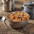 Bowl of Korean Inspired Beef on a countertop with kettle and cup in the background.