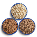 Three blue bowls filled with various proteins.