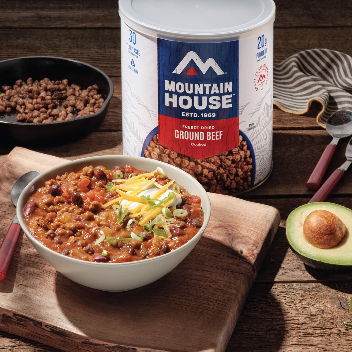 Ground Beef #10 Can on counter next to a bowl of chili.