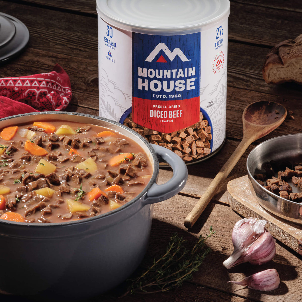 Diced Beef #10 Can on a countertop next to beef stew in a bowl.