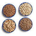 Four blue camping bowls filled with various Mountain House proteins.